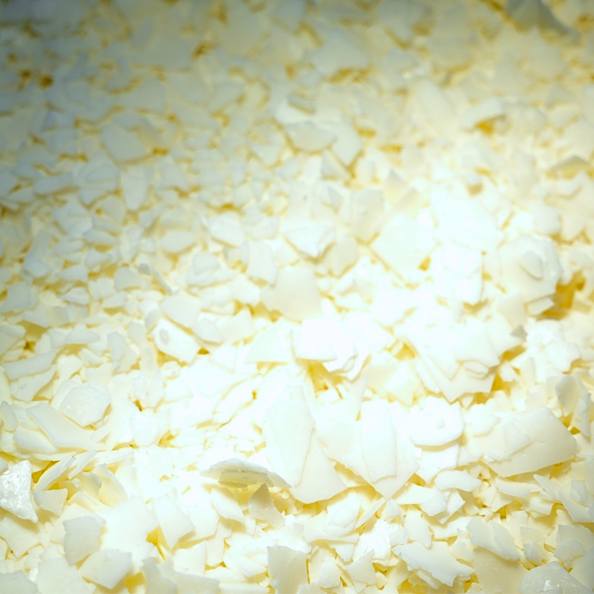 Close-up of a pile of white and yellow wax flakes.
